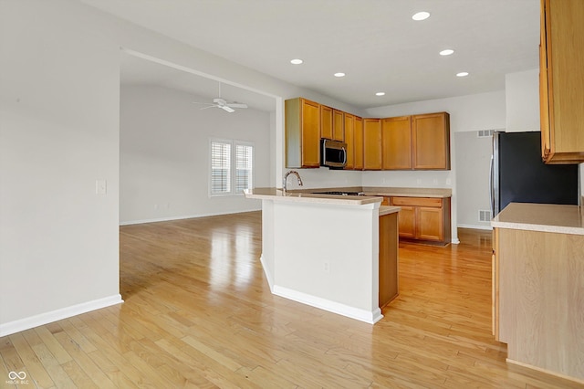 16130 Matlock Cir, Westfield, IN 46074 - kitchen with appliances with stainless steel finishes, light wood-style flooring, light countertops, recessed lighting, and ceiling fan