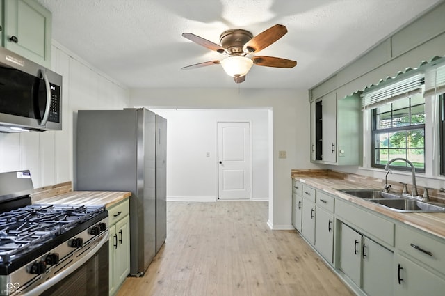 4765 E 200 N, Anderson, IN 46012 - kitchen with appliances with stainless steel finishes, green cabinetry, light wood-style floors, and ceiling fan