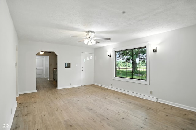 4765 E 200 N, Anderson, IN 46012 - spare room with a ceiling fan, light wood finished floors, arched walkways, and a textured ceiling
