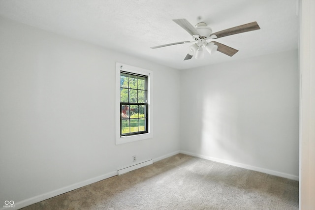 4765 E 200 N, Anderson, IN 46012 - spare room with a baseboard heating unit, carpet, and ceiling fan