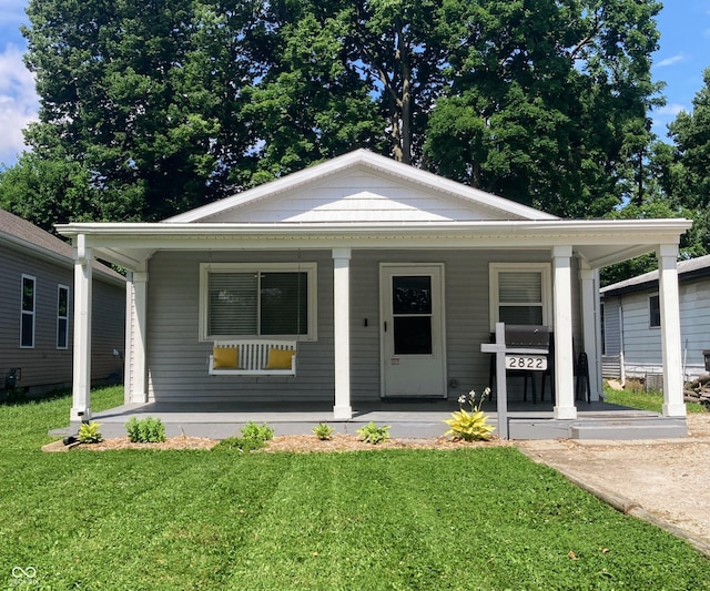 2822 Tindall St, Indianapolis, IN 46203 - view of front facade featuring a porch and a front lawn