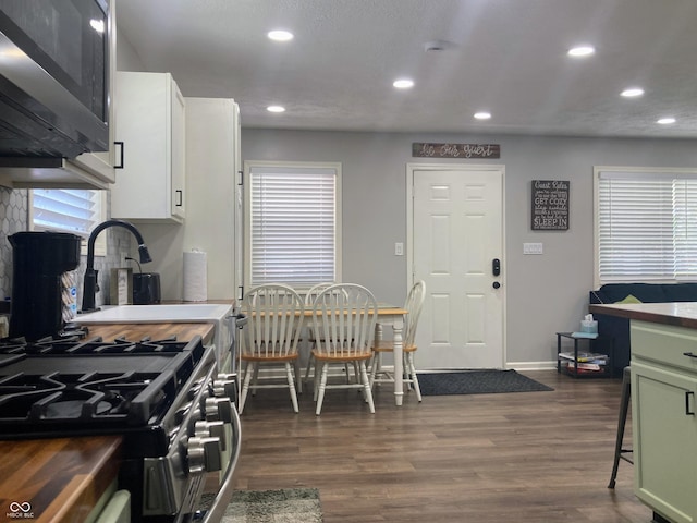 2822 Tindall St, Indianapolis, IN 46203 - kitchen with stainless steel appliances, recessed lighting, dark wood-type flooring, white cabinets, and plenty of natural light