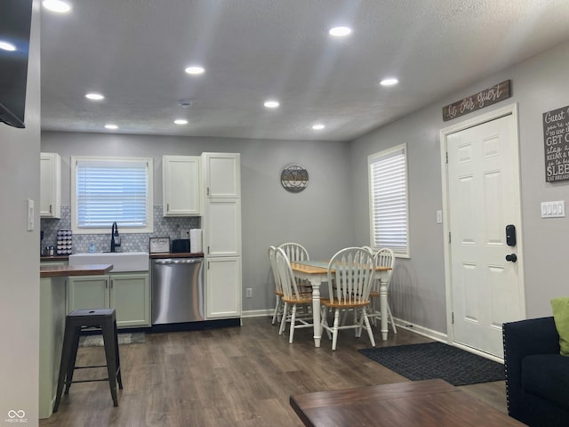 2822 Tindall St, Indianapolis, IN 46203 - kitchen with dishwasher, dark wood-type flooring, tasteful backsplash, recessed lighting, and white cabinets