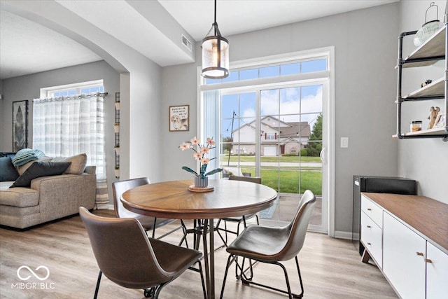 1158 Thistlewood Way, Plainfield, IN 46168 - dining space with arched walkways and light wood finished floors