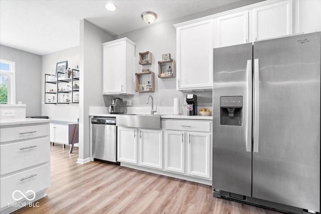1158 Thistlewood Way, Plainfield, IN 46168 - kitchen featuring appliances with stainless steel finishes, light wood-type flooring, light countertops, white cabinetry, and open shelves
