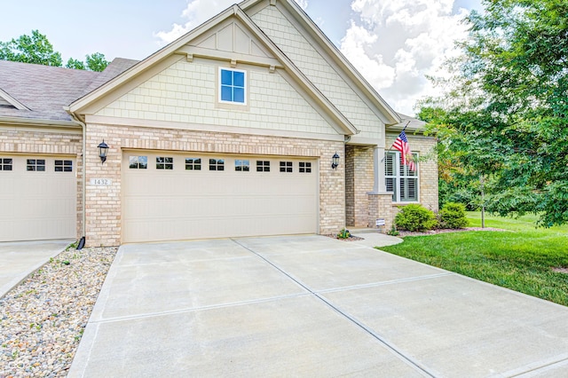 1432 Hideaway Cir, Brownsburg, IN 46112 - craftsman house featuring concrete driveway, brick siding, an attached garage, a front yard, and roof with shingles