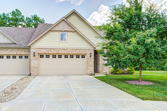 1432 Hideaway Cir, Brownsburg, IN 46112 - craftsman house featuring driveway, a front lawn, brick siding, and a garage
