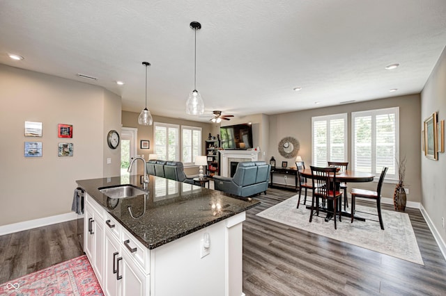 1432 Hideaway Cir, Brownsburg, IN 46112 - kitchen featuring a fireplace, dark wood-style floors, recessed lighting, a kitchen island with sink, and a ceiling fan