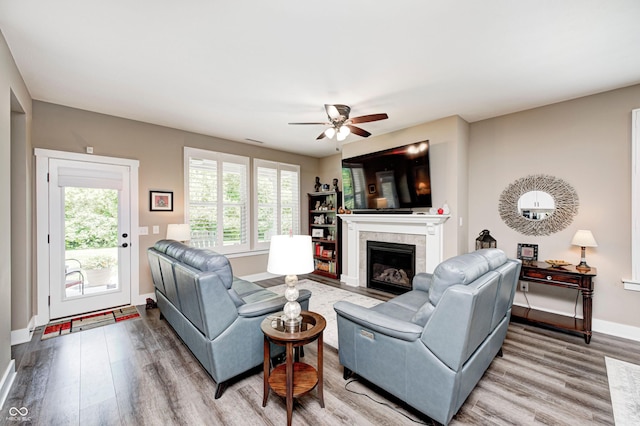 1432 Hideaway Cir, Brownsburg, IN 46112 - living room with wood finished floors, a ceiling fan, and a tiled fireplace