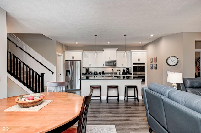 1432 Hideaway Cir, Brownsburg, IN 46112 - dining room featuring dark wood-type flooring, recessed lighting, and stairway