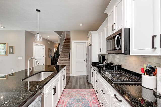 1432 Hideaway Cir, Brownsburg, IN 46112 - kitchen with appliances with stainless steel finishes, dark wood-type flooring, white cabinetry, tasteful backsplash, and decorative light fixtures