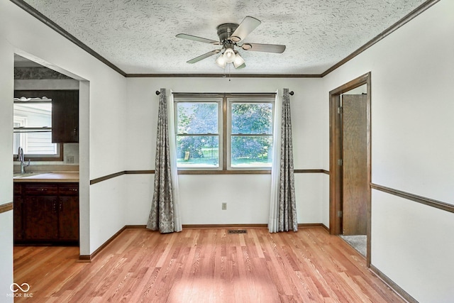 1441 N 700 W, Greenfield, IN 46140 - empty room featuring ornamental molding, light wood-style flooring, a textured ceiling, and a ceiling fan