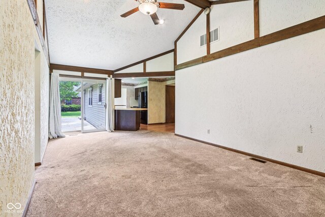 1441 N 700 W, Greenfield, IN 46140 - unfurnished living room featuring a textured wall, carpet, ceiling fan, a textured ceiling, and high vaulted ceiling