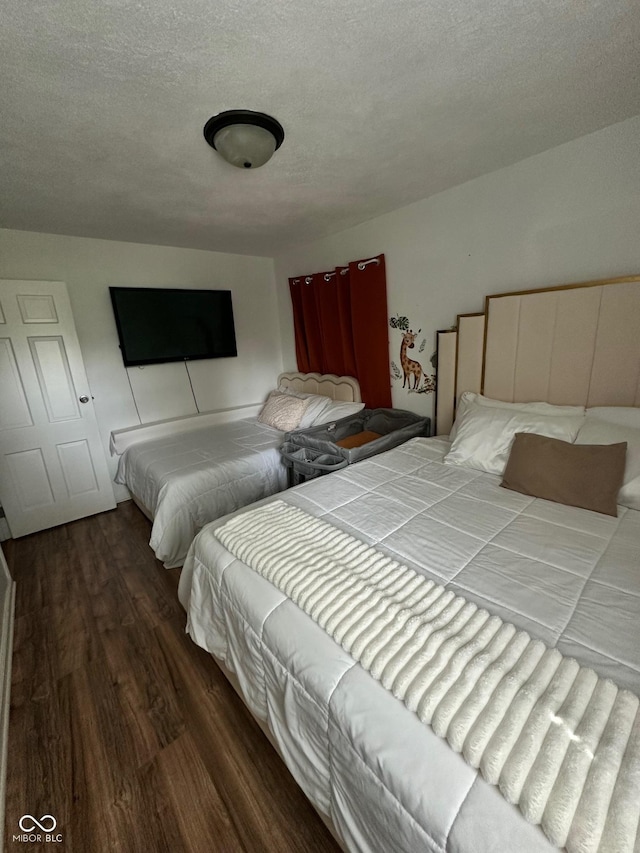 3711 Hillside Ave, Indianapolis, IN 46218 - bedroom with wood finished floors and a textured ceiling
