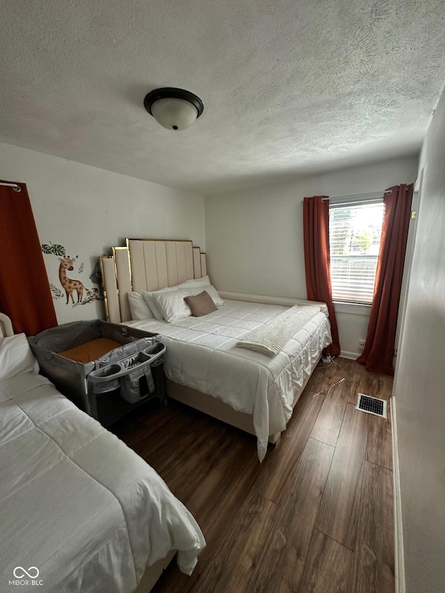 3711 Hillside Ave, Indianapolis, IN 46218 - bedroom featuring wood finished floors and a textured ceiling