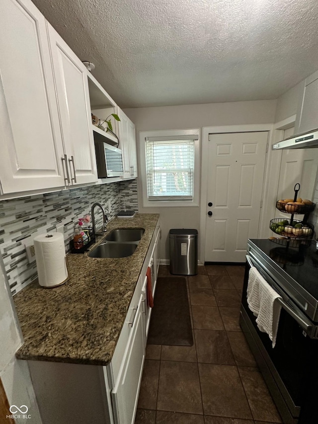 3711 Hillside Ave, Indianapolis, IN 46218 - kitchen featuring range with electric stovetop, white cabinetry, a textured ceiling, open shelves, and dark tile patterned floors