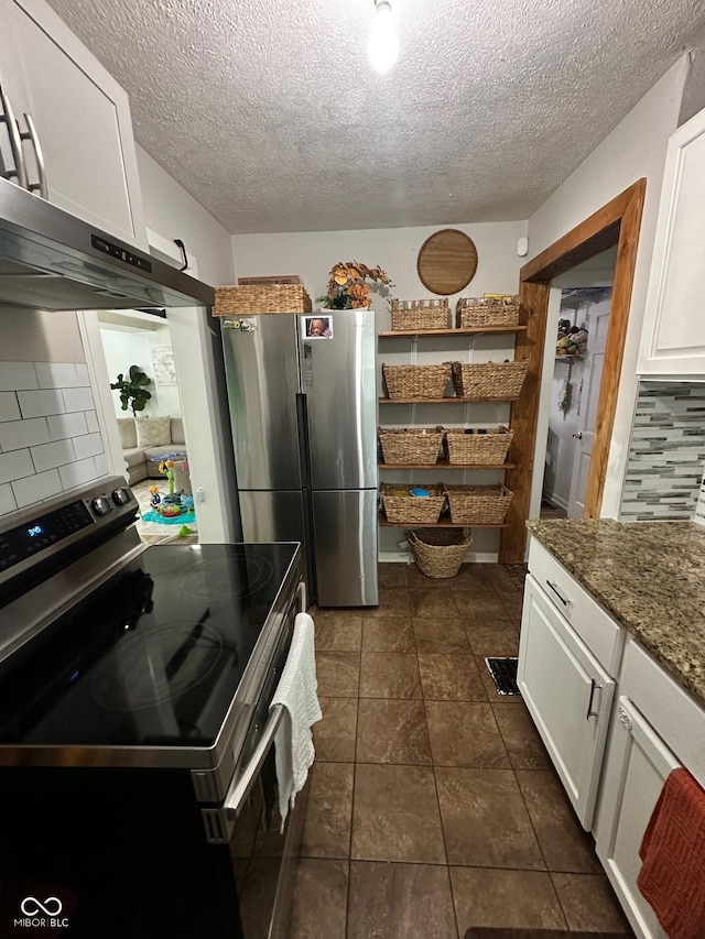 3711 Hillside Ave, Indianapolis, IN 46218 - kitchen with appliances with stainless steel finishes, a textured ceiling, white cabinets, decorative backsplash, and dark stone countertops
