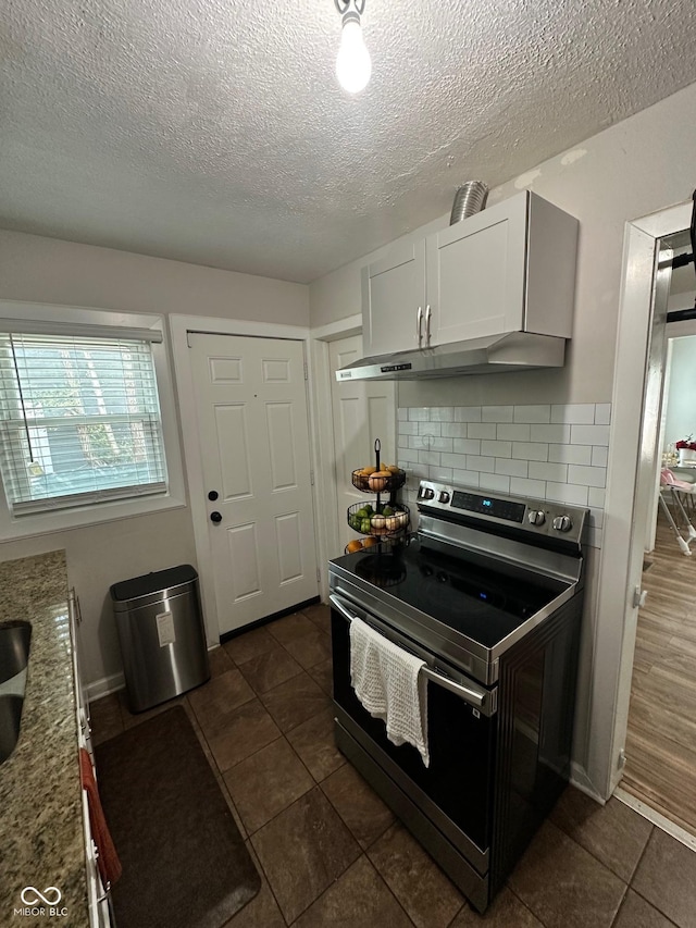 3711 Hillside Ave, Indianapolis, IN 46218 - kitchen featuring electric stove, ventilation hood, a textured ceiling, white cabinets, and decorative backsplash