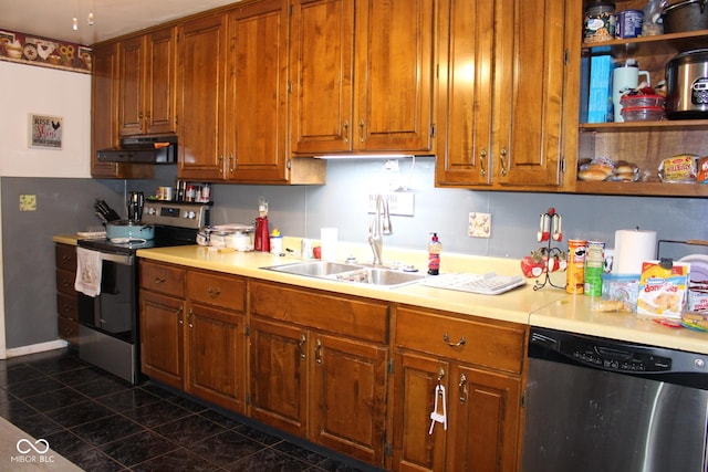 1504 Gwinn Ln, Lapel, IN 46051 - kitchen with appliances with stainless steel finishes, under cabinet range hood, light countertops, dark tile patterned floors, and brown cabinetry