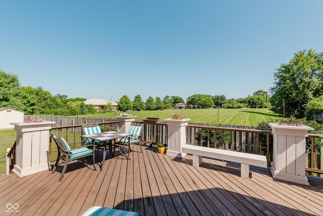 7092 Bridgemont Ct, Avon, IN 46123 - wooden terrace with outdoor dining space, a lawn, and view of scattered trees
