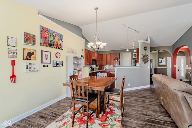 7092 Bridgemont Ct, Avon, IN 46123 - dining space with dark wood-type flooring, a chandelier, arched walkways, vaulted ceiling, and track lighting