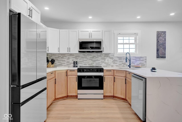 301 Beech Rd, North Vernon, IN 47265 - kitchen featuring appliances with stainless steel finishes, light wood-style floors, tasteful backsplash, light stone countertops, and recessed lighting