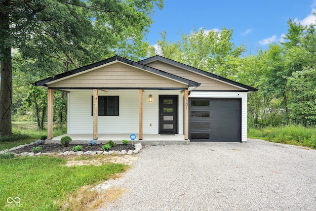 301 Beech Rd, North Vernon, IN 47265 - view of front of property featuring driveway, covered porch, and an attached garage