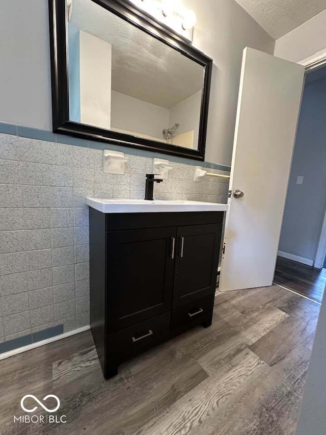 1941 W Booe Rd, Austin, IN 47102 - bathroom featuring tile walls, wood finished floors, and vanity