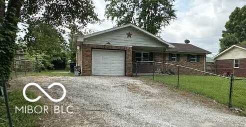 1941 W Booe Rd, Austin, IN 47102 - ranch-style house with an attached garage and driveway