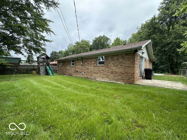 1941 W Booe Rd, Austin, IN 47102 - view of side of home with a playground, brick siding, and a patio
