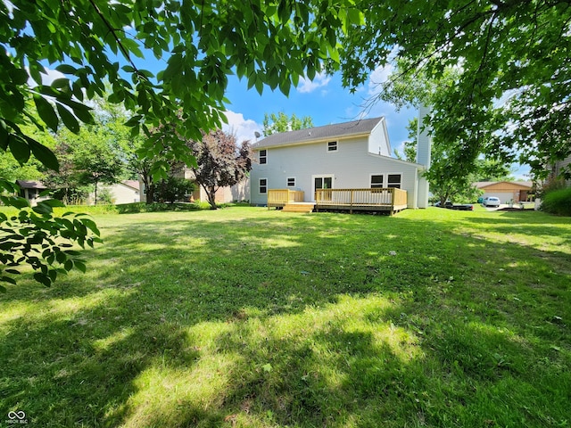 4536 Clayburn Dr, Indianapolis, IN 46268 - view of grassy yard featuring a deck
