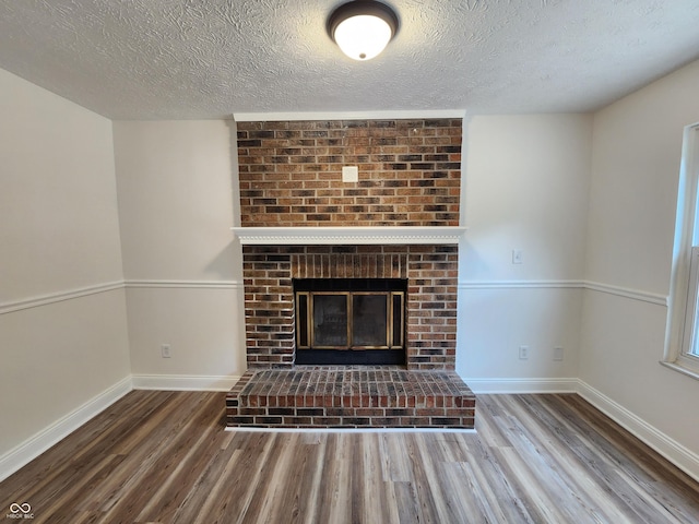 4536 Clayburn Dr, Indianapolis, IN 46268 - detailed view of wood finished floors, a textured ceiling, and a brick fireplace
