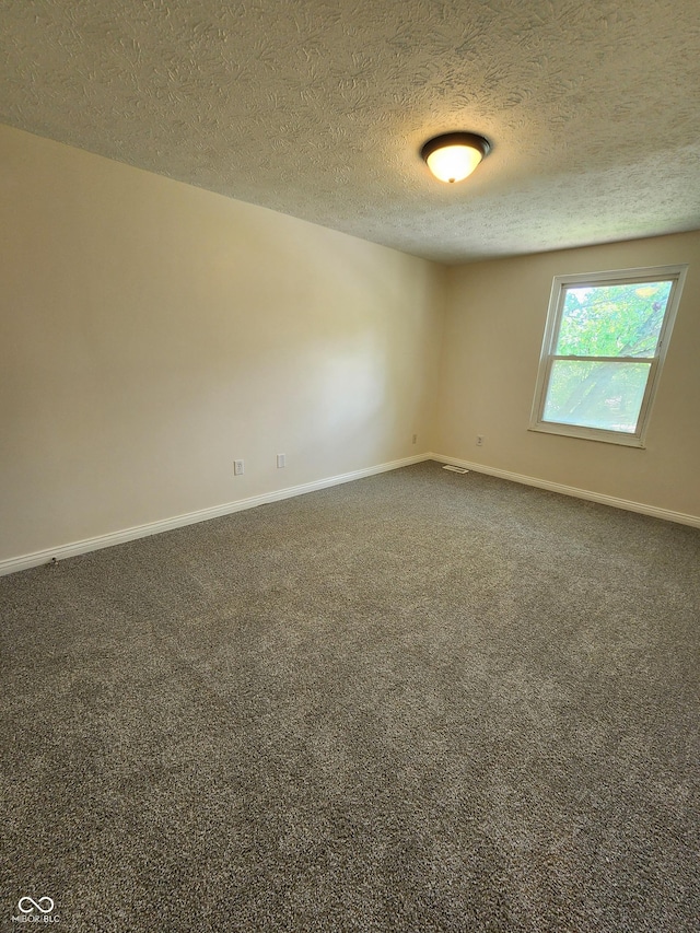 4536 Clayburn Dr, Indianapolis, IN 46268 - carpeted empty room with a textured ceiling and baseboards
