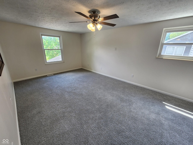 4536 Clayburn Dr, Indianapolis, IN 46268 - unfurnished room featuring a textured ceiling, plenty of natural light, a ceiling fan, and carpet