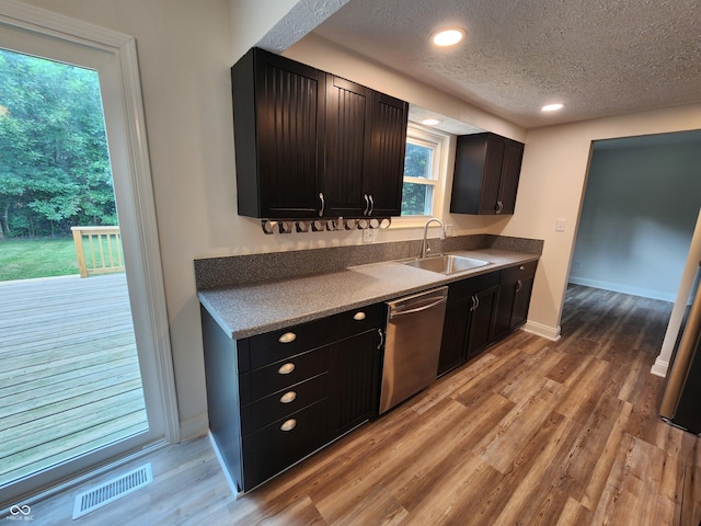 4536 Clayburn Dr, Indianapolis, IN 46268 - kitchen featuring dishwasher, a textured ceiling, light wood-style floors, and recessed lighting