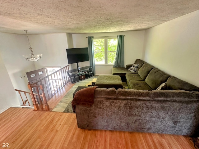 7607 Ardwell Ct, Indianapolis, IN 46237 - living room featuring a chandelier, wood finished floors, and a textured ceiling