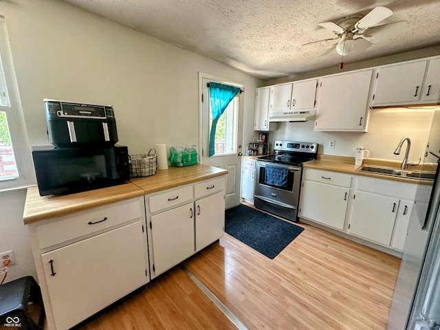 7607 Ardwell Ct, Indianapolis, IN 46237 - kitchen featuring stainless steel range with electric cooktop, under cabinet range hood, black microwave, light wood-style flooring, and white cabinets