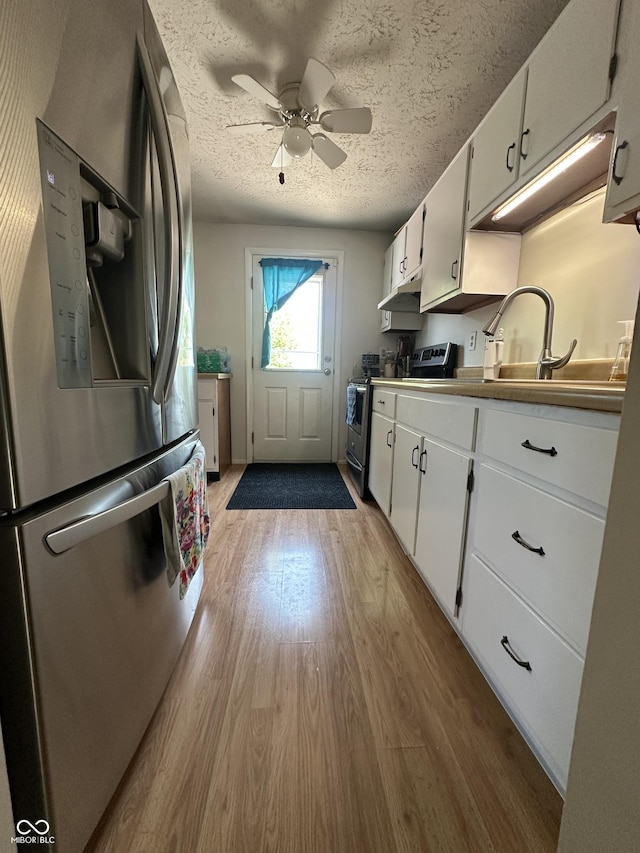 7607 Ardwell Ct, Indianapolis, IN 46237 - kitchen with stainless steel appliances, wood finished floors, white cabinets, under cabinet range hood, and a ceiling fan