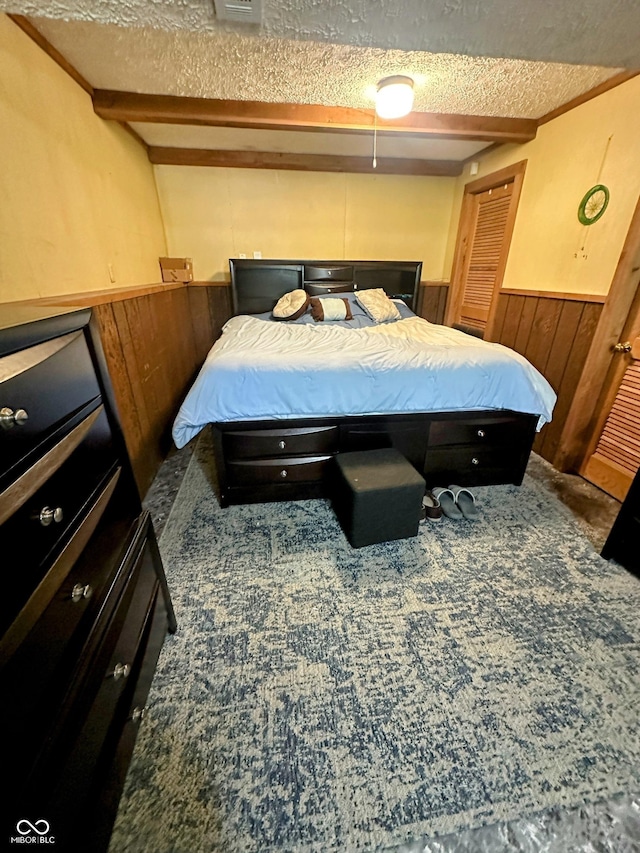 7607 Ardwell Ct, Indianapolis, IN 46237 - bedroom featuring a textured ceiling, wainscoting, carpet floors, and wooden walls
