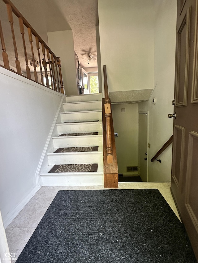 7607 Ardwell Ct, Indianapolis, IN 46237 - staircase featuring a ceiling fan and a textured ceiling