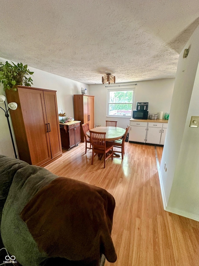 7607 Ardwell Ct, Indianapolis, IN 46237 - dining space featuring light wood finished floors and a textured ceiling