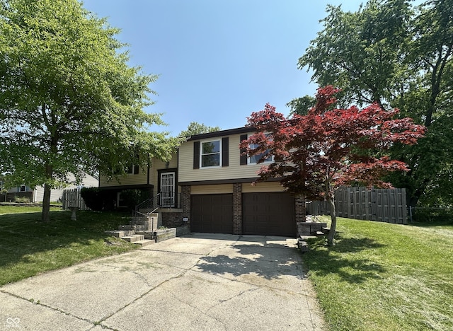 7607 Ardwell Ct, Indianapolis, IN 46237 - split foyer home with a garage, concrete driveway, and brick siding