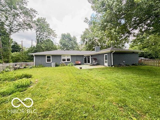 6546 Derbyshire Rd, Indianapolis, IN 46227 - rear view of property with a patio area, a chimney, and a fenced backyard