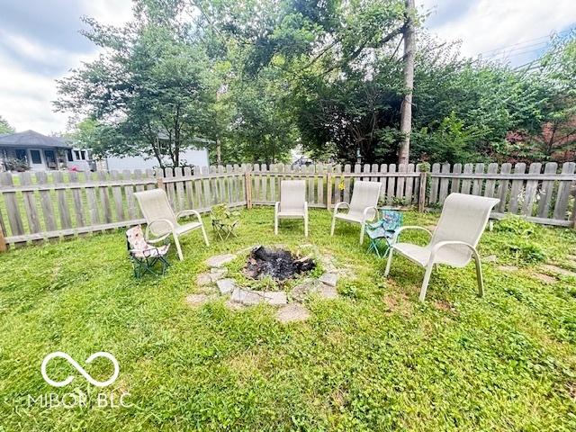 6546 Derbyshire Rd, Indianapolis, IN 46227 - fenced backyard featuring an outdoor fire pit