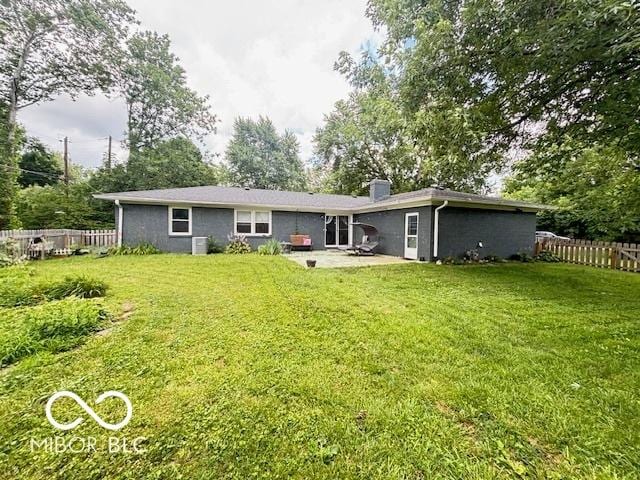 6546 Derbyshire Rd, Indianapolis, IN 46227 - rear view of house with a patio and a chimney