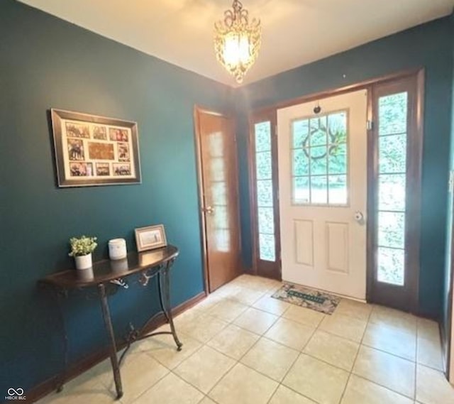 6546 Derbyshire Rd, Indianapolis, IN 46227 - foyer entrance with light tile patterned flooring and a chandelier