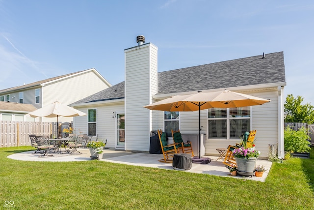 10585 Windward Dr, Indianapolis, IN 46234 - back of property with a patio area, roof with shingles, and a chimney