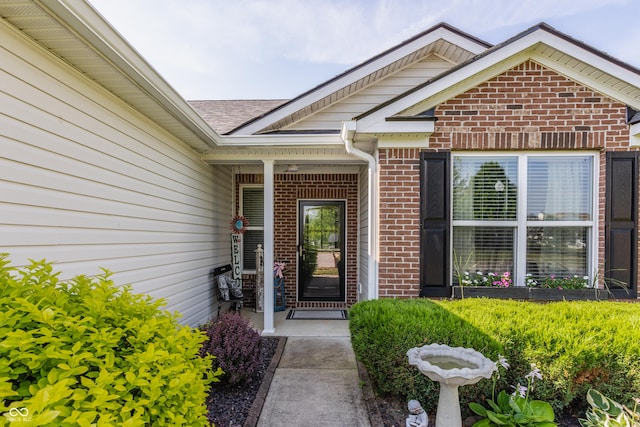 10585 Windward Dr, Indianapolis, IN 46234 - view of exterior entry with brick siding and roof with shingles