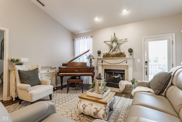 10585 Windward Dr, Indianapolis, IN 46234 - living area with wood finished floors, lofted ceiling, a tiled fireplace, and recessed lighting