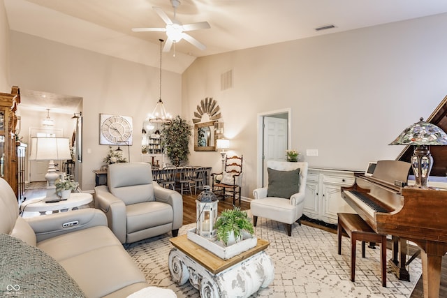 10585 Windward Dr, Indianapolis, IN 46234 - living area with ceiling fan, high vaulted ceiling, a chandelier, and light wood finished floors